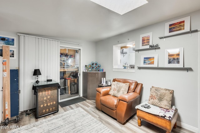 10374 W Deanne Dr, Sun City, AZ 85351 - living area featuring baseboards, wood finished floors, and a skylight