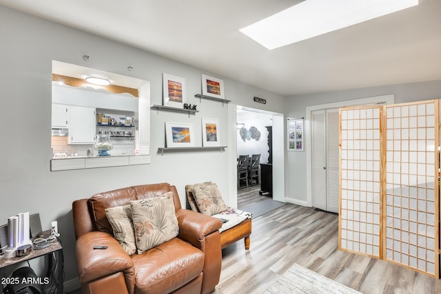 10374 W Deanne Dr, Sun City, AZ 85351 - living area featuring baseboards and light wood-type flooring