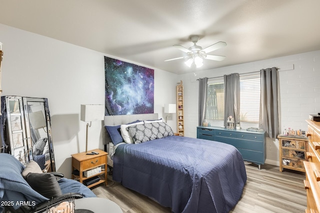 10374 W Deanne Dr, Sun City, AZ 85351 - bedroom with light wood finished floors and ceiling fan