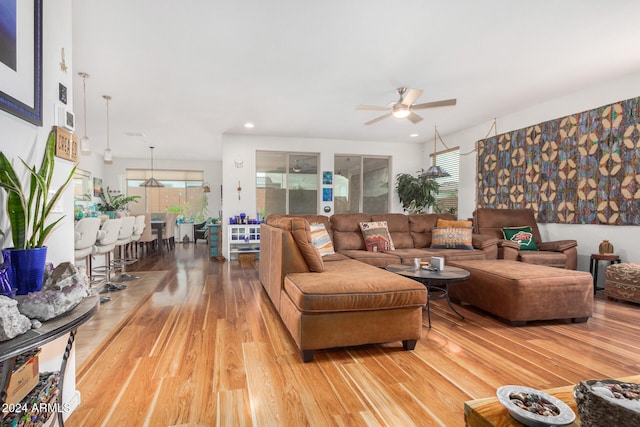 living room featuring hardwood / wood-style flooring and ceiling fan