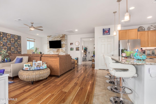 living room featuring light hardwood / wood-style floors and ceiling fan