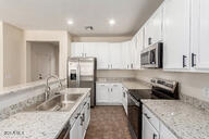 11834 N 147th Ln, Surprise, AZ 85379 - kitchen featuring stainless steel appliances, a sink, white cabinetry, and recessed lighting