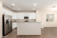 11834 N 147th Ln, Surprise, AZ 85379 - kitchen featuring stainless steel fridge, white cabinets, a center island, and recessed lighting