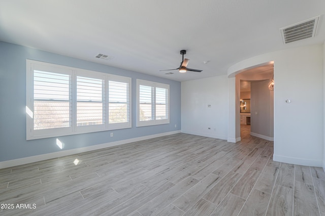 spare room featuring light wood-type flooring and ceiling fan