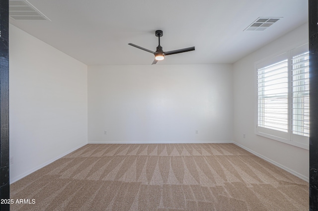 carpeted spare room with ceiling fan