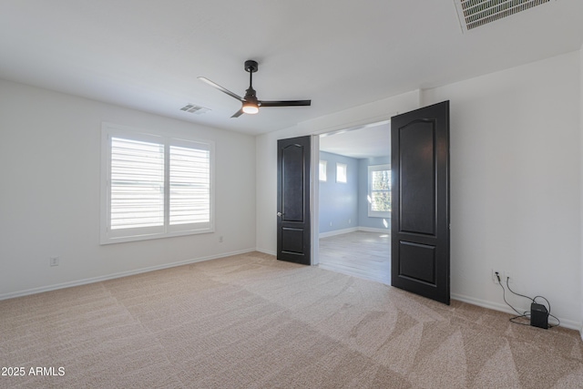 carpeted spare room with ceiling fan