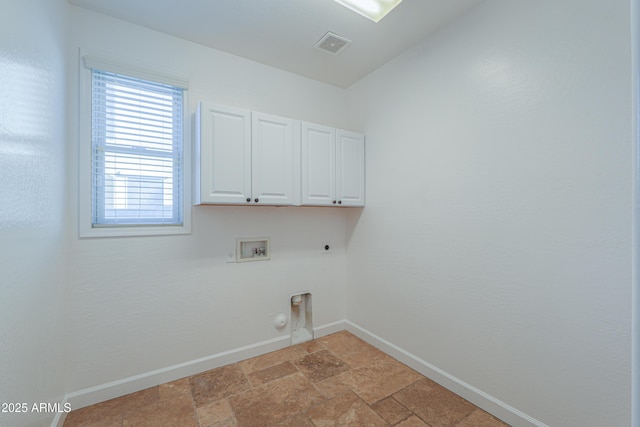 clothes washing area featuring hookup for a washing machine, cabinets, hookup for an electric dryer, and hookup for a gas dryer