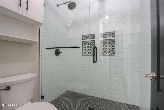 bathroom featuring toilet and an enclosed shower