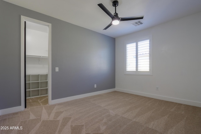 unfurnished room featuring ceiling fan and light colored carpet