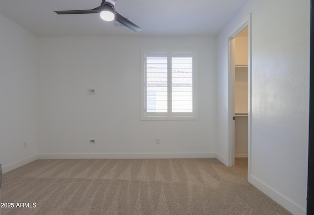 carpeted spare room with ceiling fan