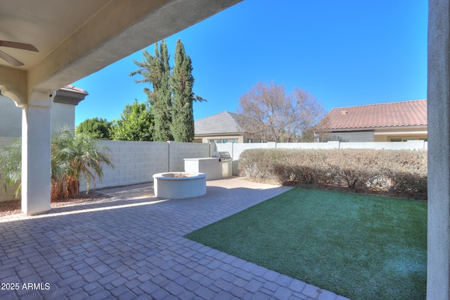 view of yard with a patio area, ceiling fan, and a fire pit