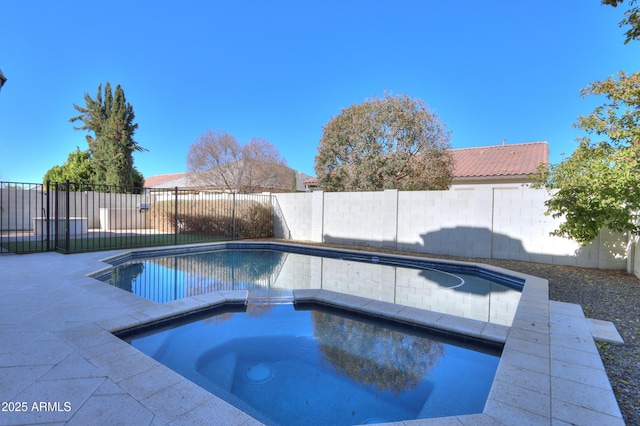 view of swimming pool featuring an in ground hot tub