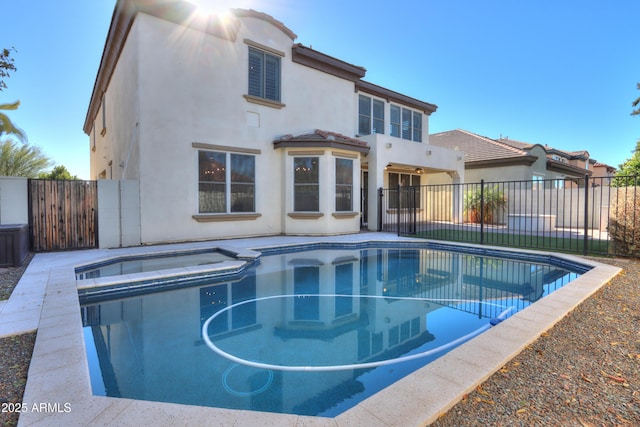 view of swimming pool featuring an in ground hot tub