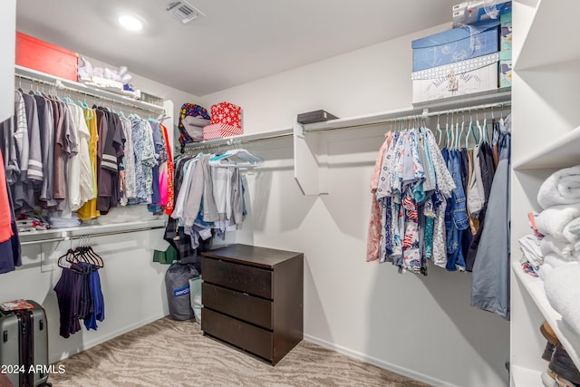 spacious closet featuring light carpet