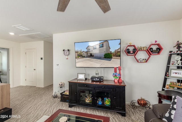 living room featuring ceiling fan and carpet