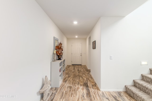 corridor with light hardwood / wood-style floors