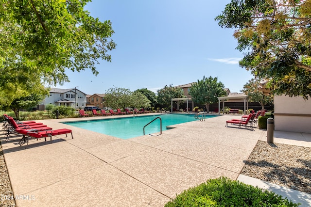 view of pool with a pergola and a patio