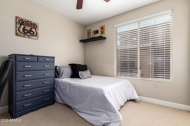 bedroom featuring baseboards, a ceiling fan, and light colored carpet