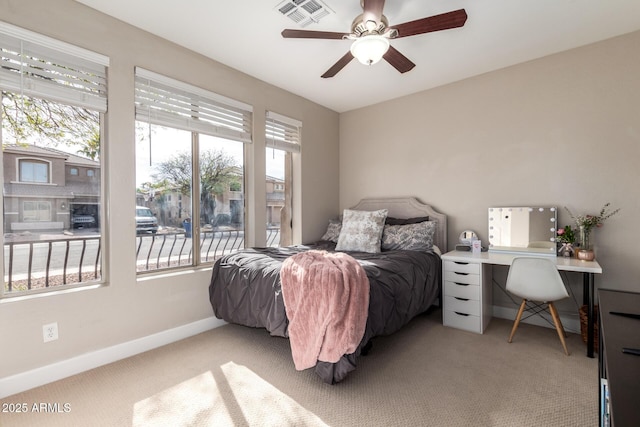 bedroom with visible vents, ceiling fan, light carpet, and baseboards