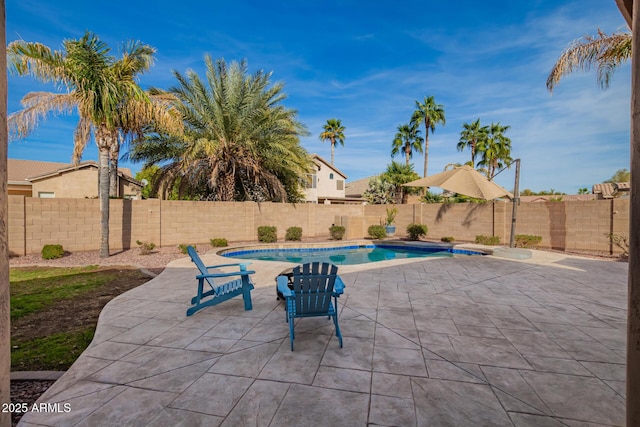 view of swimming pool with a patio and a fenced backyard