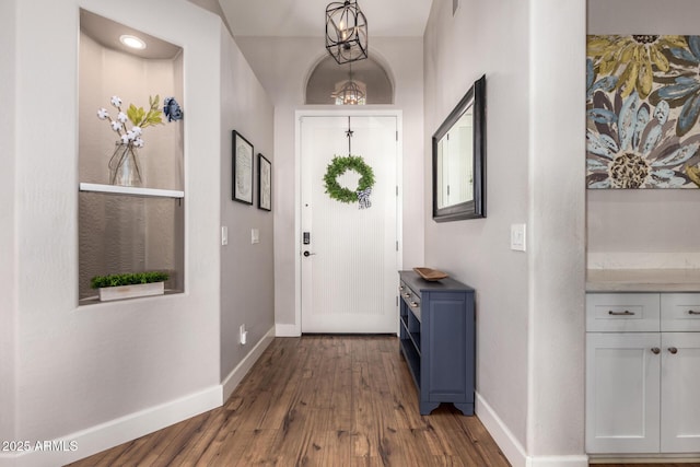 entryway featuring dark wood-style flooring and baseboards