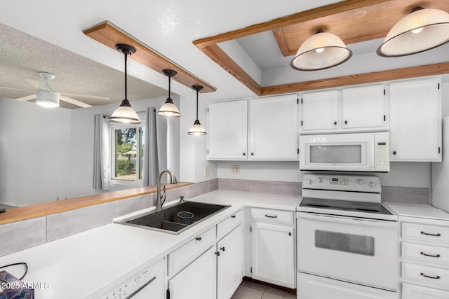 kitchen featuring white appliances, white cabinets, light countertops, and a sink