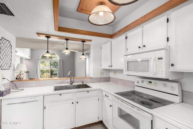 kitchen with visible vents, light countertops, white appliances, white cabinetry, and a sink