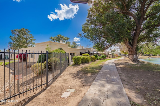 view of front of house featuring stucco siding and fence