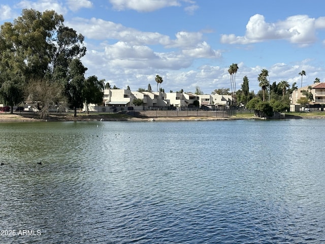 water view featuring a residential view and fence