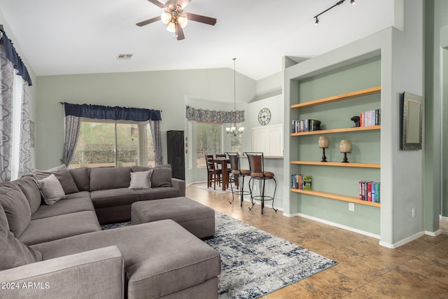 living room featuring built in shelves, ceiling fan with notable chandelier, and vaulted ceiling