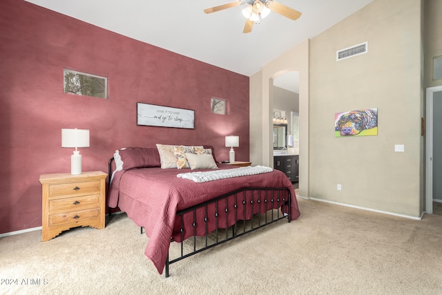 carpeted bedroom with ceiling fan, connected bathroom, and vaulted ceiling