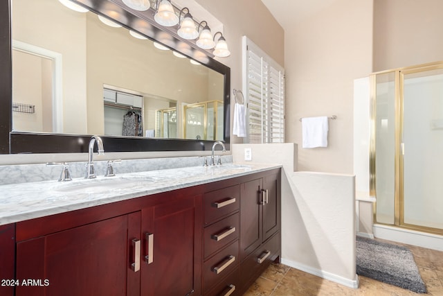 bathroom with walk in shower and vanity