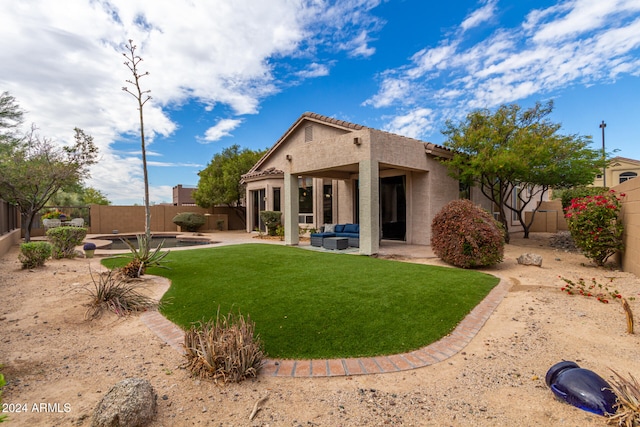 rear view of property with a yard, an outdoor hangout area, and a patio area