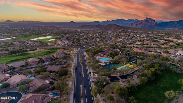 aerial view at dusk featuring a mountain view