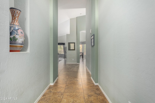 hall featuring lofted ceiling