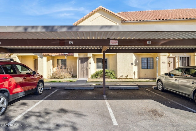 view of building exterior featuring covered parking