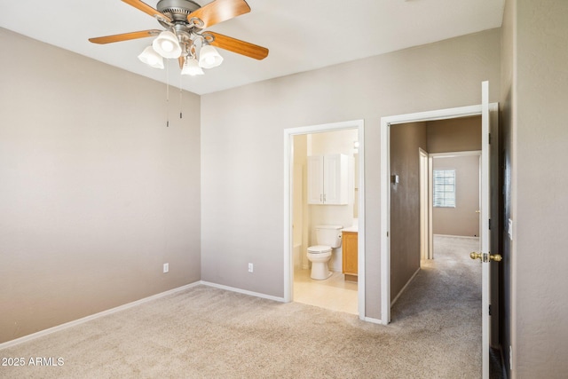 unfurnished bedroom with carpet floors, baseboards, a ceiling fan, and ensuite bathroom