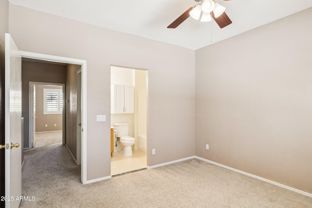 unfurnished bedroom featuring carpet flooring, baseboards, and ensuite bathroom