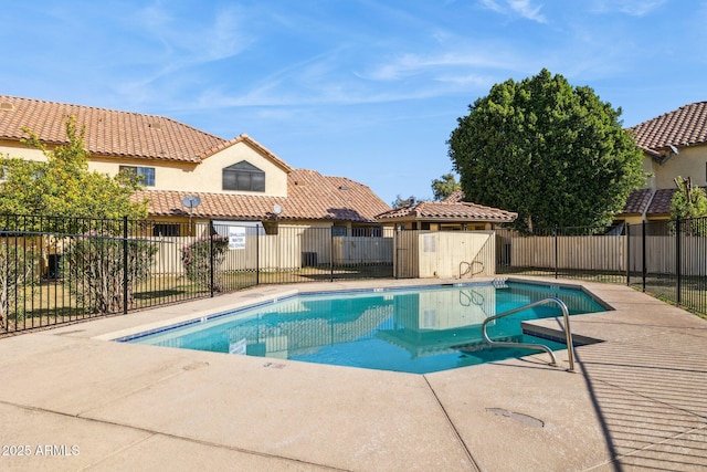 pool featuring fence and a patio