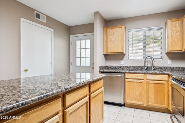 kitchen featuring a healthy amount of sunlight, light tile patterned floors, visible vents, and appliances with stainless steel finishes