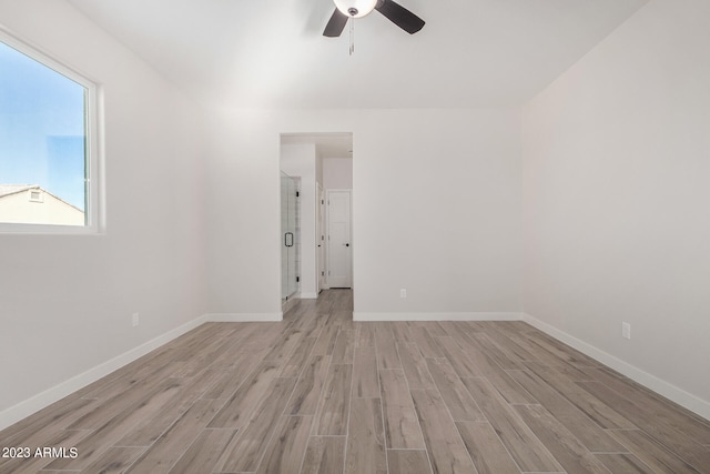 empty room with light hardwood / wood-style floors and ceiling fan