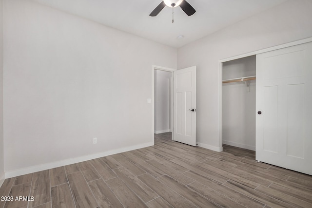 unfurnished bedroom featuring ceiling fan, a closet, and light hardwood / wood-style flooring