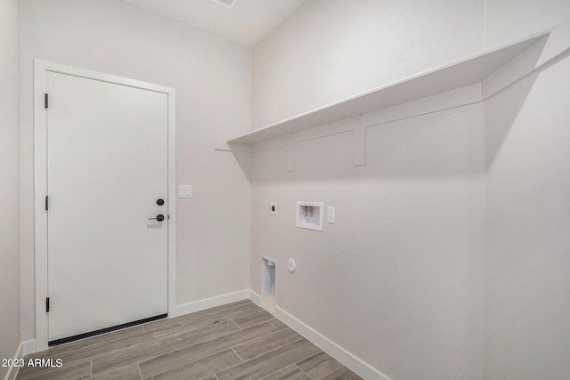 washroom with washer hookup, gas dryer hookup, light hardwood / wood-style floors, and electric dryer hookup