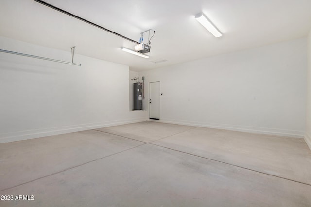 garage featuring water heater and a garage door opener