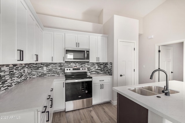 kitchen featuring appliances with stainless steel finishes, sink, and white cabinets