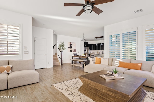 living room featuring ceiling fan and wood-type flooring