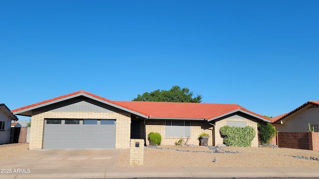 650 N 65th Way, Mesa, AZ 85205 - ranch-style home with an attached garage, a tile roof, driveway, and brick siding