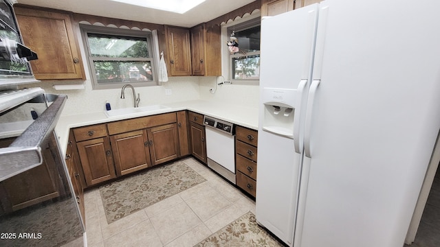 650 N 65th Way, Mesa, AZ 85205 - kitchen with white appliances, a sink, plenty of natural light, and light tile patterned floors