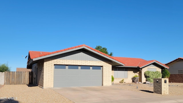 650 N 65th Way, Mesa, AZ 85205 - ranch-style house featuring an attached garage, a tiled roof, driveway, and brick siding