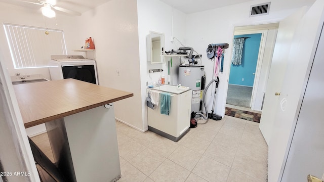 650 N 65th Way, Mesa, AZ 85205 - kitchen featuring washer and clothes dryer, electric water heater, a ceiling fan, light tile patterned floors, and baseboards